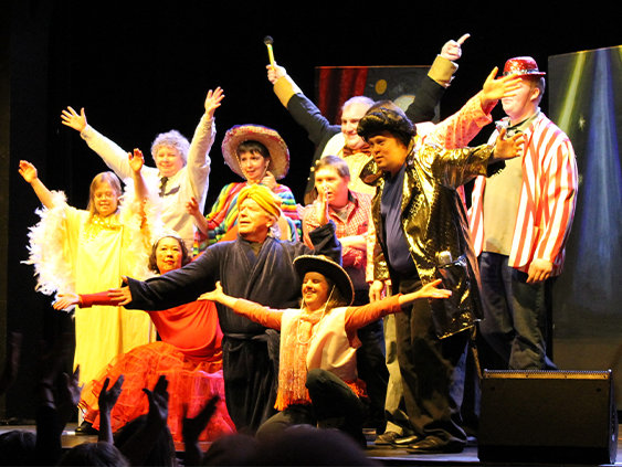 Adults on stage at theatre performing